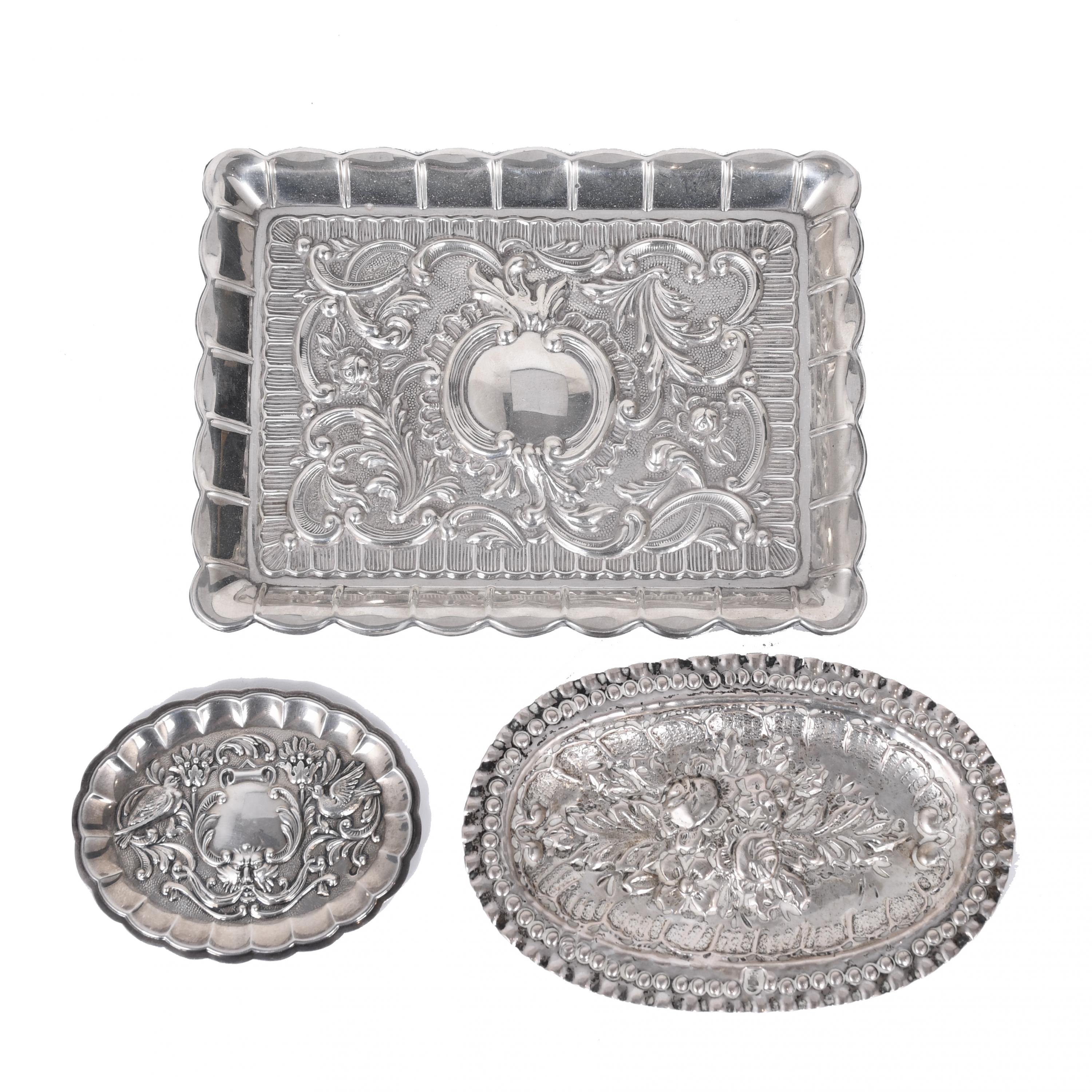 THREE SILVER TRAYS IN HISTORICIST STYLE, 20TH CENTURY. 
