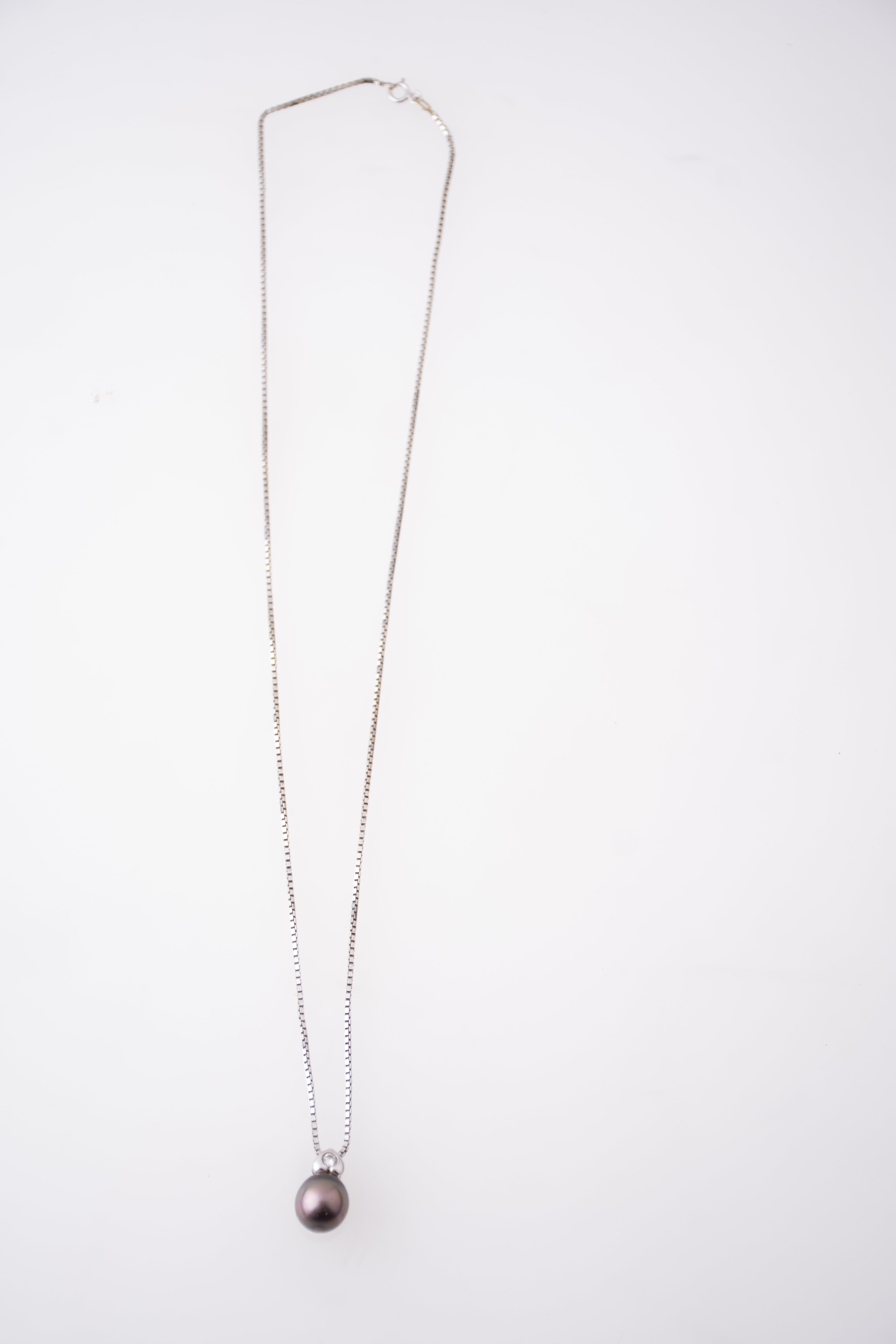 Necklace with Tahiti pearl and diamond pendant.