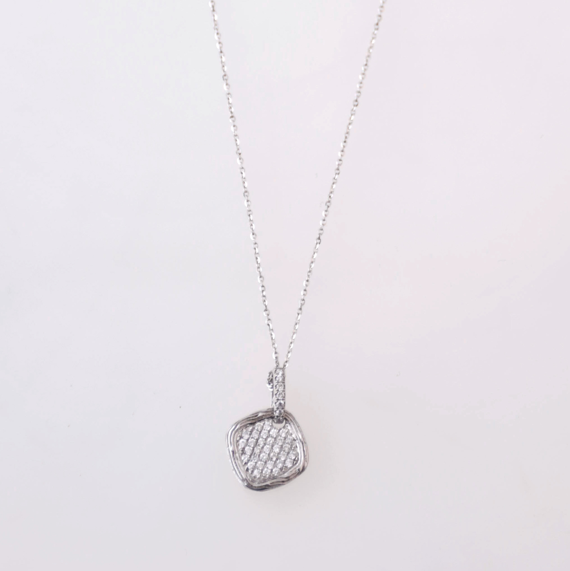 Rhombus-shaped pendant necklace with diamonds.
