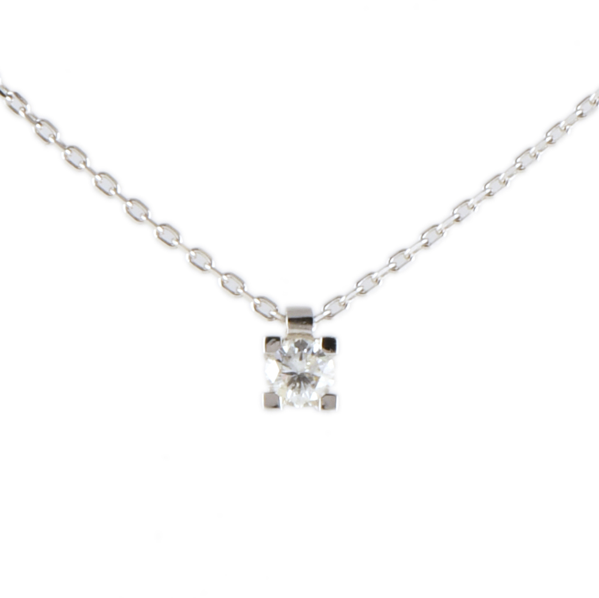 Necklace with a single diamond pendant.