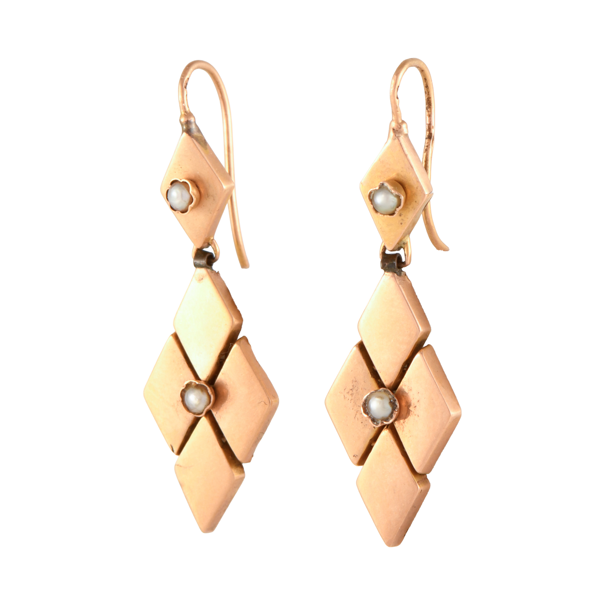 Long diamond-shaped earrings with pearls.
