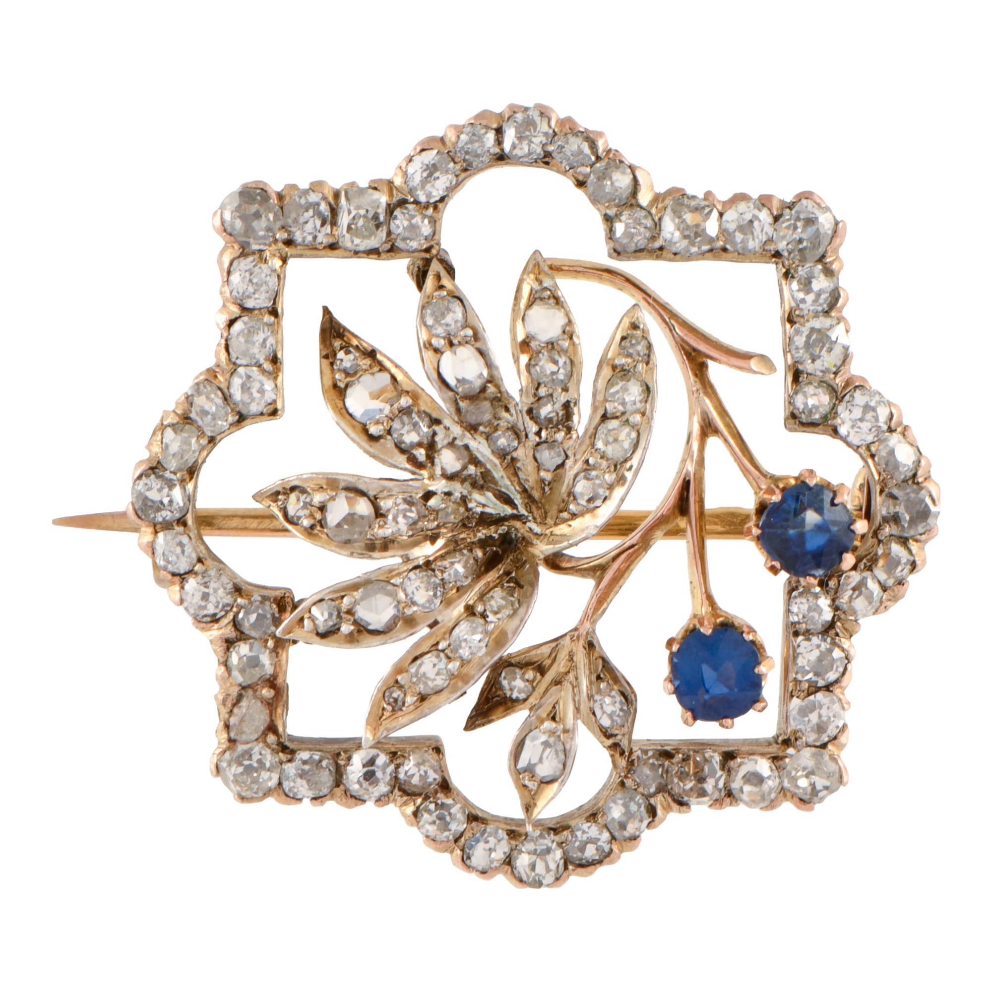 Broche noucentista en forma floral con diamantes y zafiros.