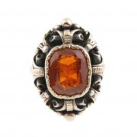 73-Silver and gold with central garnet 1,3x1,1x cm.Ring size 16 mm.11,7 gr.