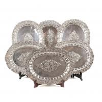 40-Oval trays embossed with floral decoration. 26 x 32,5 cms.1792 gr.Some hallmarked.Small dents.