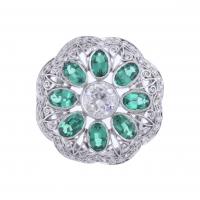 37-LARGE ROSETTE RING WITH SYNTHETIC EMERALDS AND DIAMONDS.