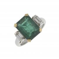 58-RING WITH EMERALD AND TWO SIDE DIAMONDS.