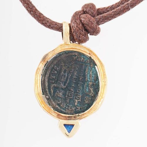 COIN PENDANT WITH GOLD TRIM.