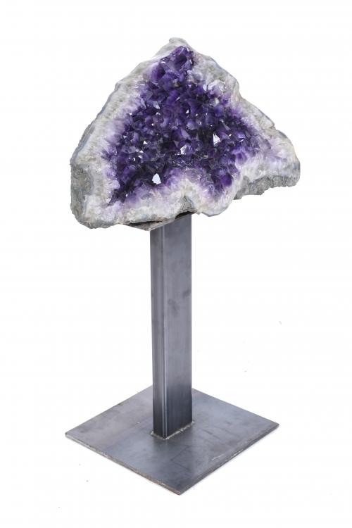 LARGE AMETHYST GEODE ON A PEDESTAL.