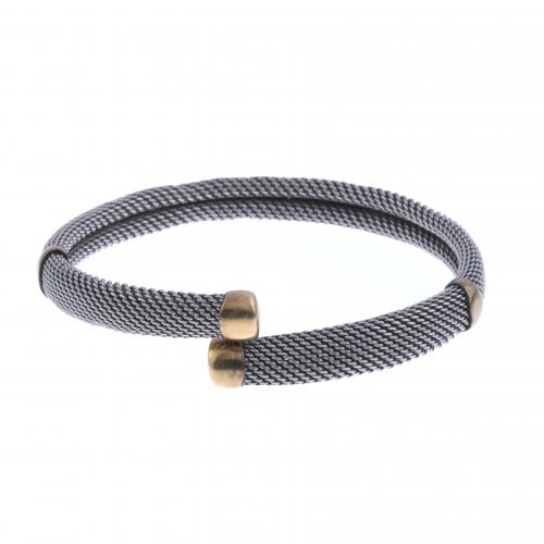 STEEL AND GOLD BANGLE BRACELET.