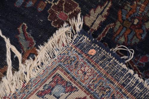 PERSIAN CARPET IN REDDISH AND BLUISH TONES.