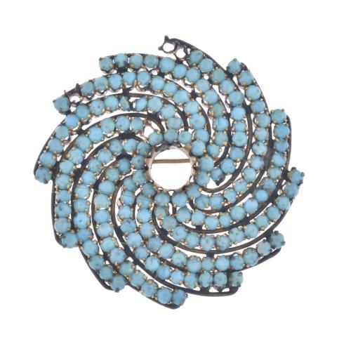 Spiral-shaped brooch with turquoises.
