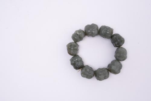20TH CENTURY CHINESE SCHOOL. Bracelet with Buddha heads.