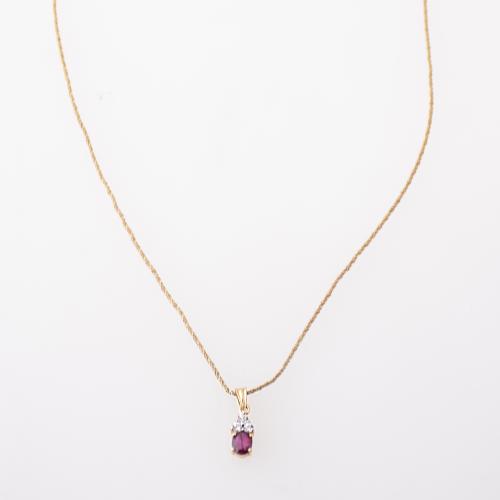 Necklace with ruby and white sapphire pendant.