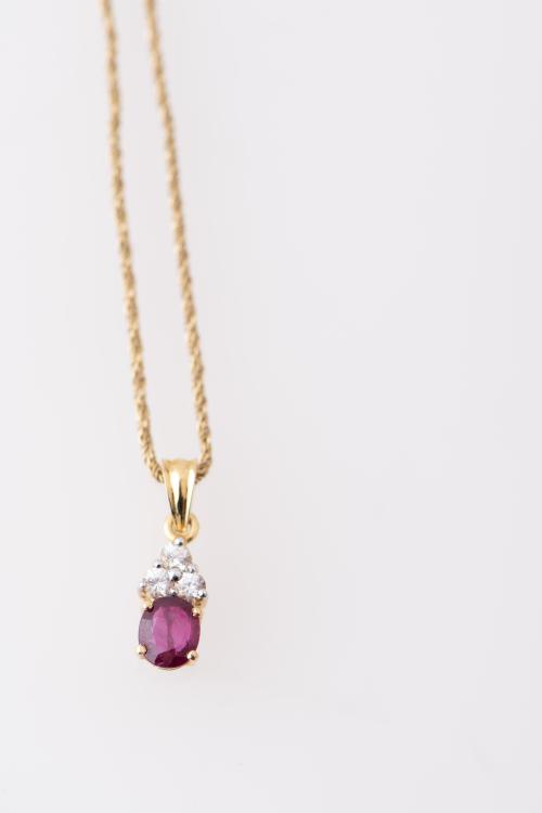 Necklace with ruby and white sapphire pendant.