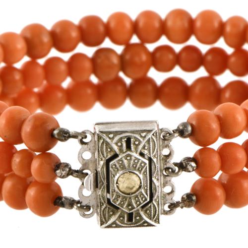 Art Deco-style bracelet with three strands of coral beads.