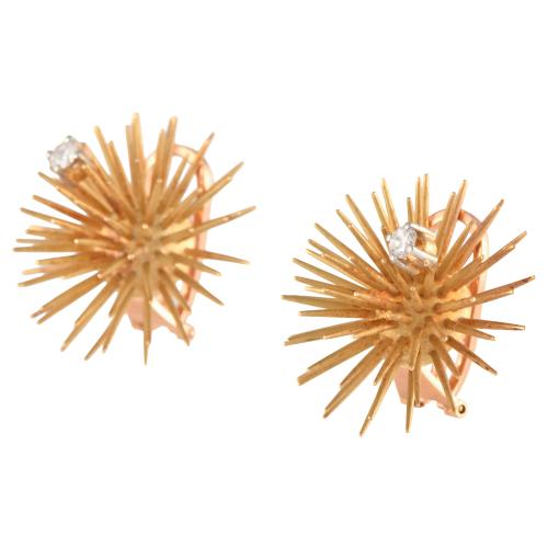 Floral brooch and earrings set with diamonds.