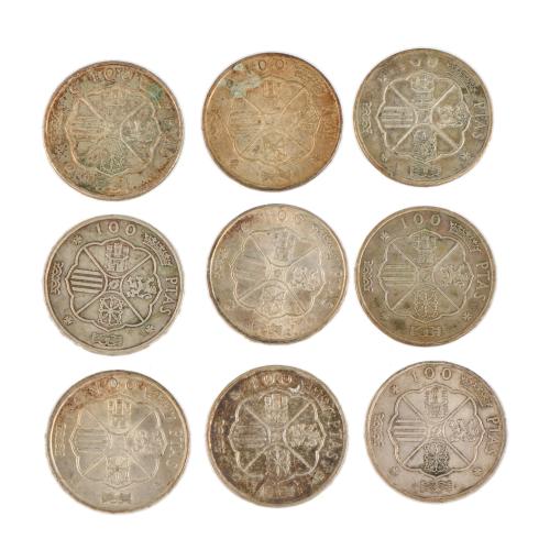 Lot of nine 100-peseta coins.