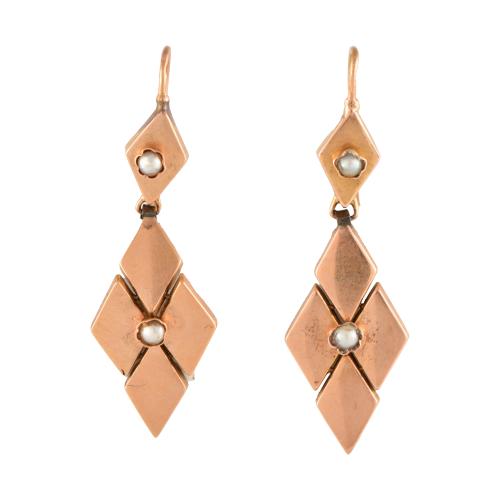 Long diamond-shaped earrings with pearls.