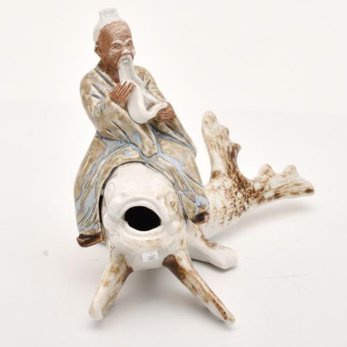 AFTER CHINESE MODELS, Figure of an old man on a Koi, 20th c
