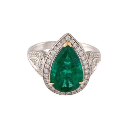 Anillo con esmeralda orlada de diamantes.